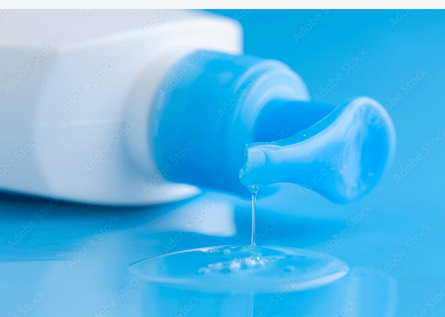 How to Choose the Best Lubricant bottle dispensing liquid on a blue background for optimal safety and compatibility.