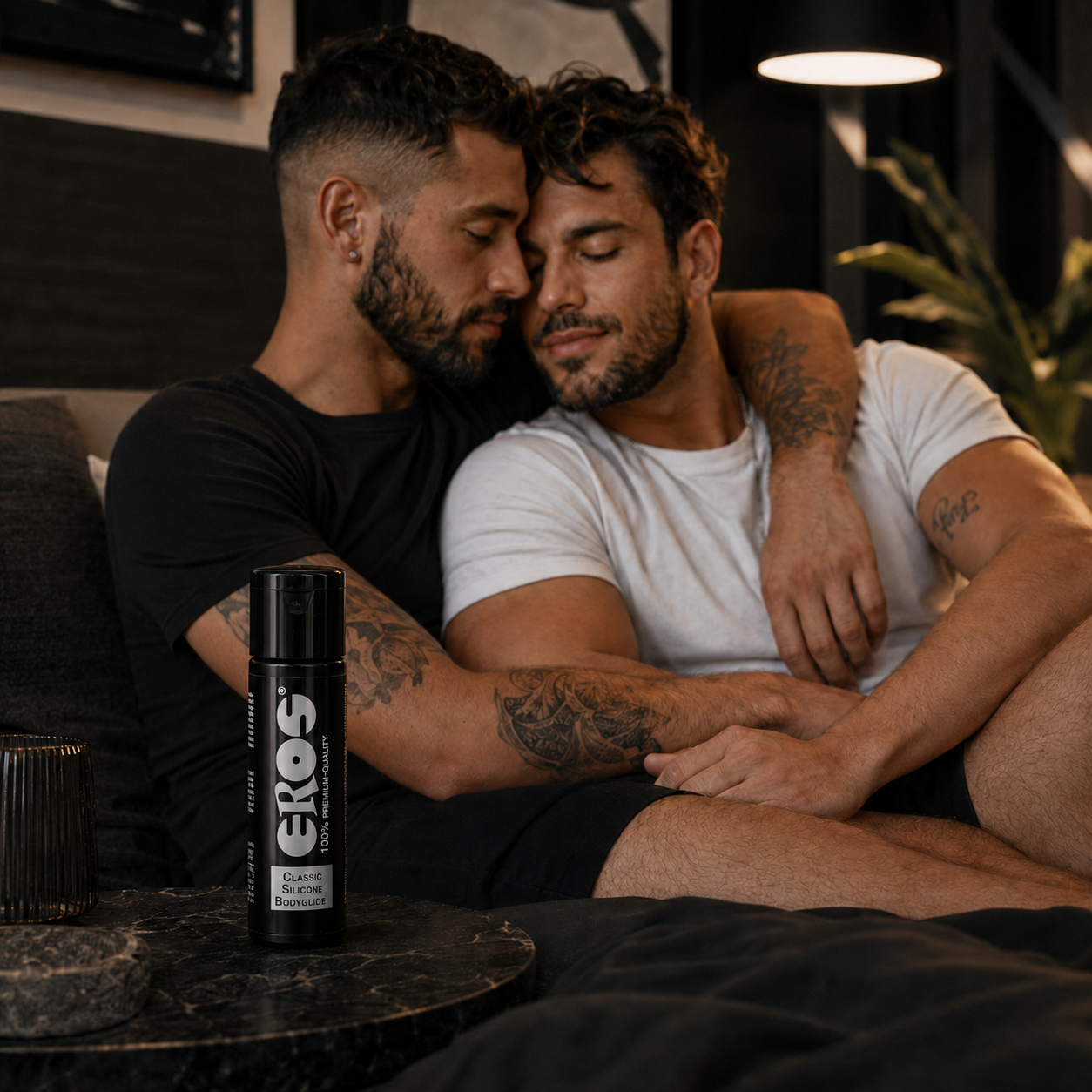 Gay male couple relaxing together with Eros classic silicone bodyglide in the foreground