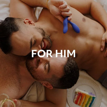 Two men sharing an intimate moment with a prostate massager, promoting the collection For Men.