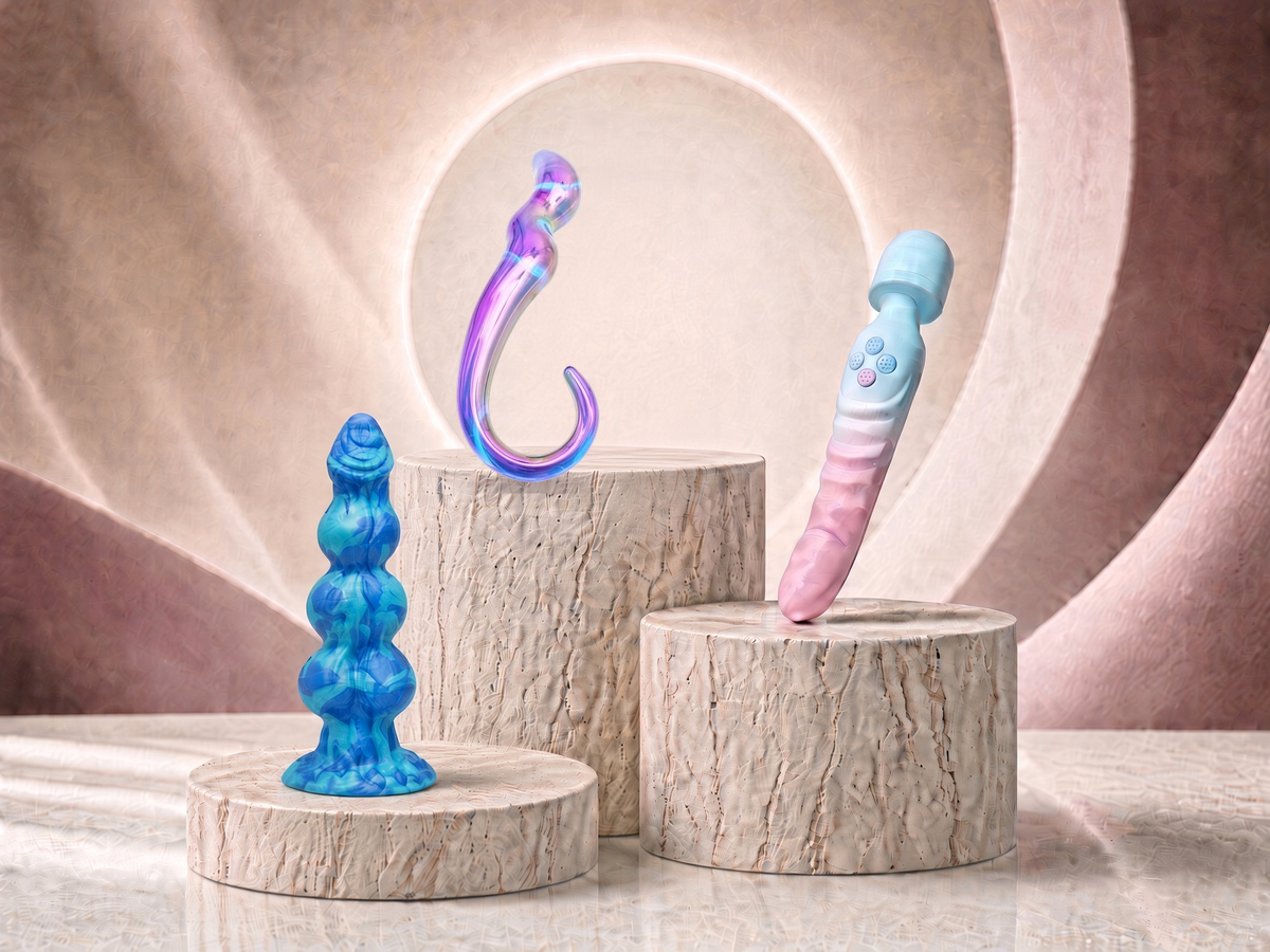 Three G-Spot dildo designs with curved and targeted shapes displayed on stone pedestals