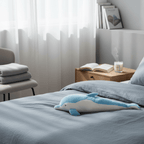 Dolphin Plush Thrusting Dildo Vibrator displayed on a neatly made bed in a stylish bedroom setting.