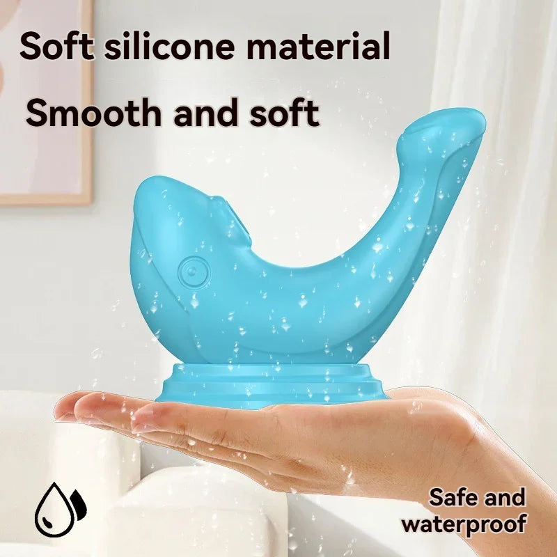 Blue silicone adult wellness toy shaped like a whale, waterproof and soft, shown on a hand.