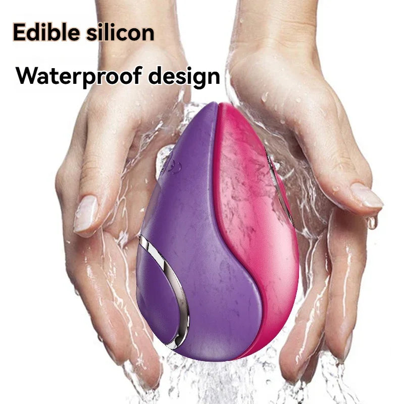 Waterproof purple and pink silicone adult toy held under running water, ergonomic design.