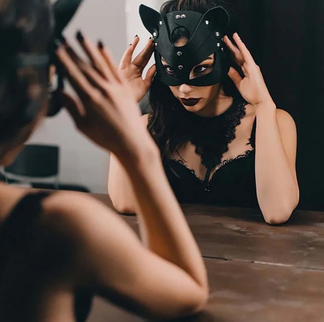Leather Fox Mask for Women worn by a woman in front of a mirror, showcasing its design and fit.