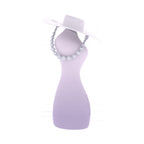 Stylish female torso vibrator with built-in lubrication and a chic hat and bead necklace for an elegant display.
