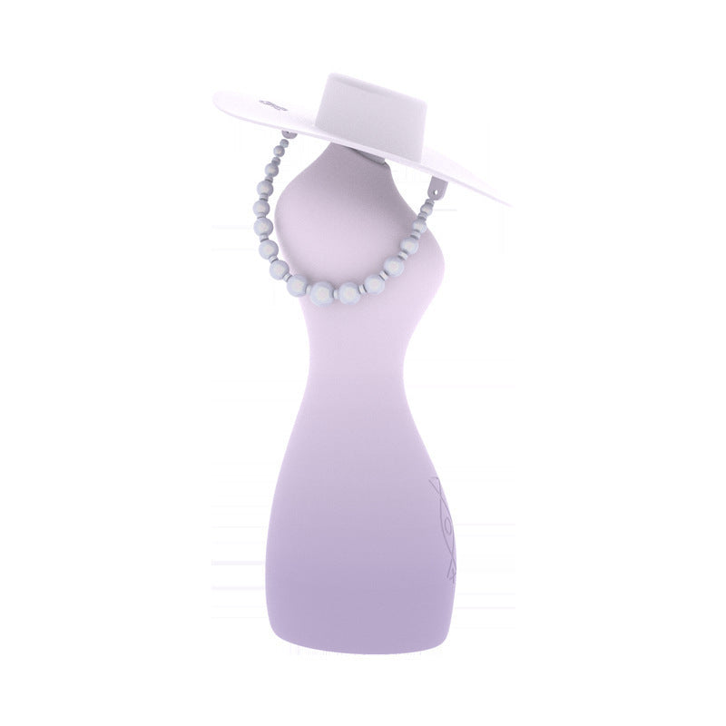 Stylish female torso vibrator with built-in lubrication and a chic hat and bead necklace for an elegant display.