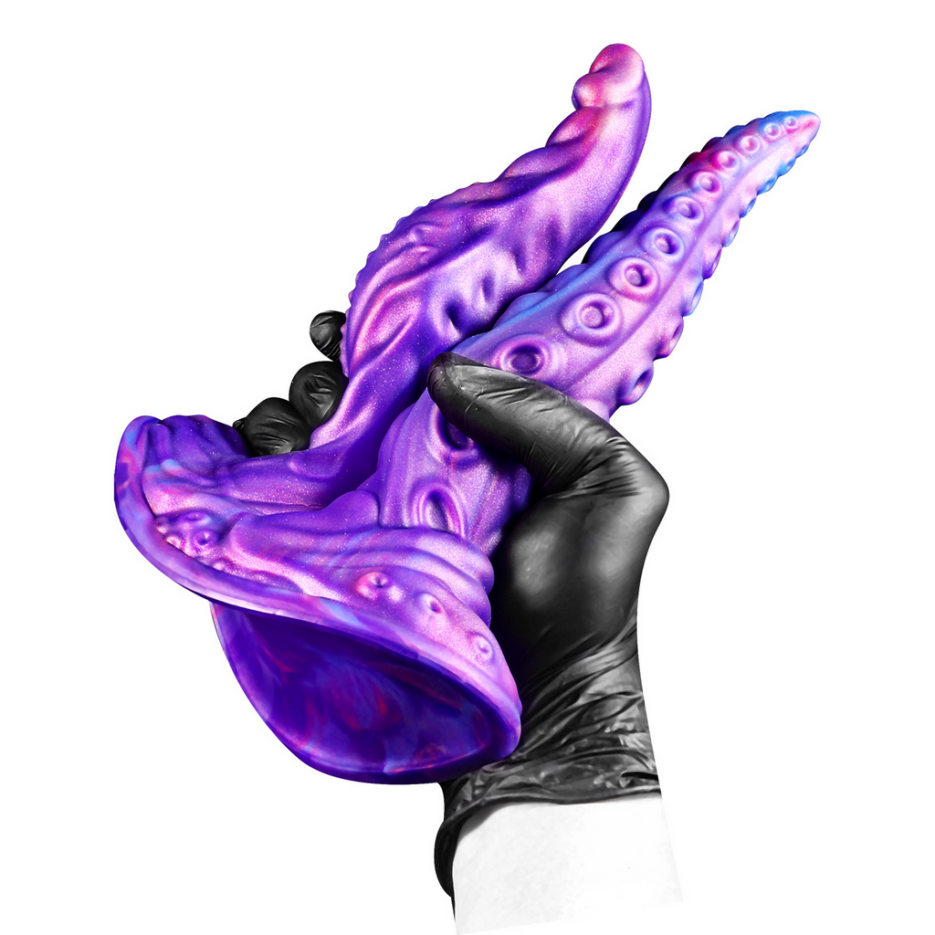 Purple dual-texture fantasy dildo held from the underside to show the wide suction-style base