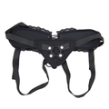 Black adjustable lace-trim strap-on harness laid flat with adjustable straps and front ring holder