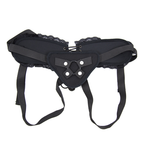 Black adjustable lace-trim strap-on harness laid flat with adjustable straps and front ring holder