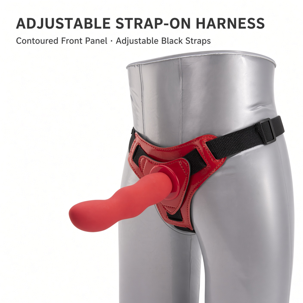 Red adjustable strap-on harness on a mannequin with contoured front panel and black straps