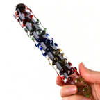 Handheld scale reference photo of multicolor raised-bubble glass dildo