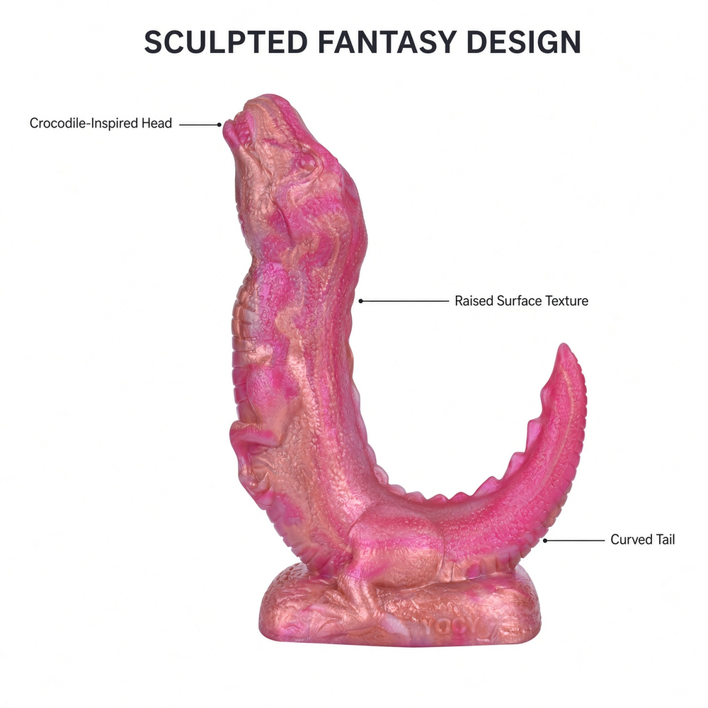 Pink and gold crocodile-inspired fantasy dildo with labeled sculpted head, raised texture and curved tail