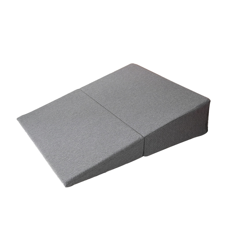 Gray folding sex positioning wedge pillow shown in its fully opened incline configuration