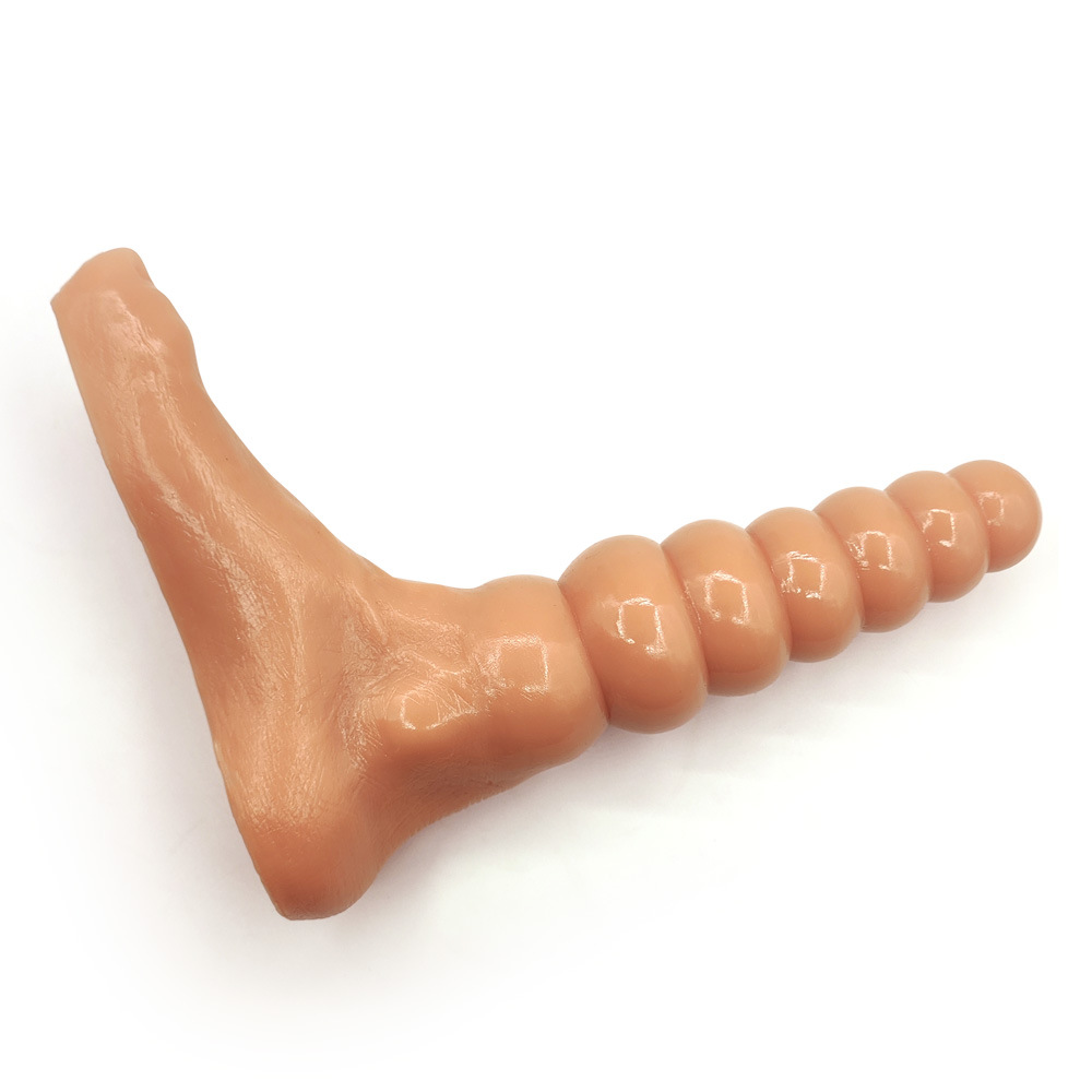 Flesh-tone beaded fantasy foot toy photographed horizontally on white