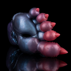Close-up of fantasy monster claw masturbator showing one channel opening between molded talons