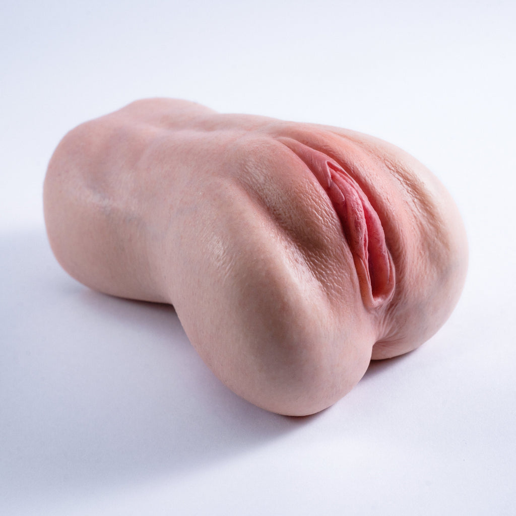 A handheld, lifelike vaginal masturbator featuring a realistic skin tone throughout, with lifelike skin texture and labia——Realistic Pocket Pussy Masturbator