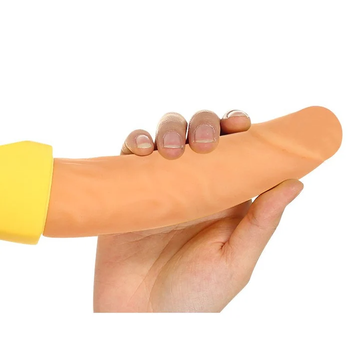 Hand holding the soft silicone shaft of a banana-shaped vibrator