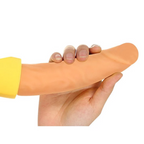 Hand holding the soft silicone shaft of a banana-shaped vibrator