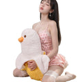 Woman seated with the BlissEntry banana duck plush sex toy