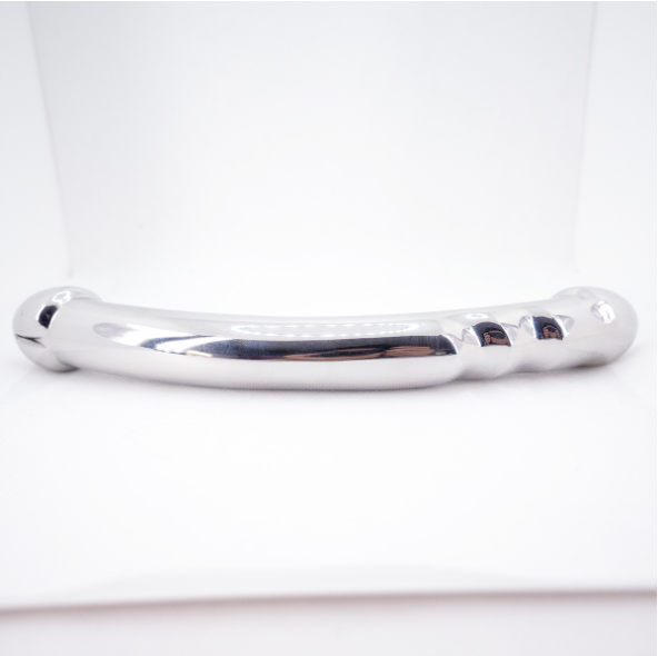 Angled close-up of the polished silver metal wand's contoured end and shaped grip section