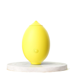 Yellow lemon-shaped clitoral suction vibrator on white display stand