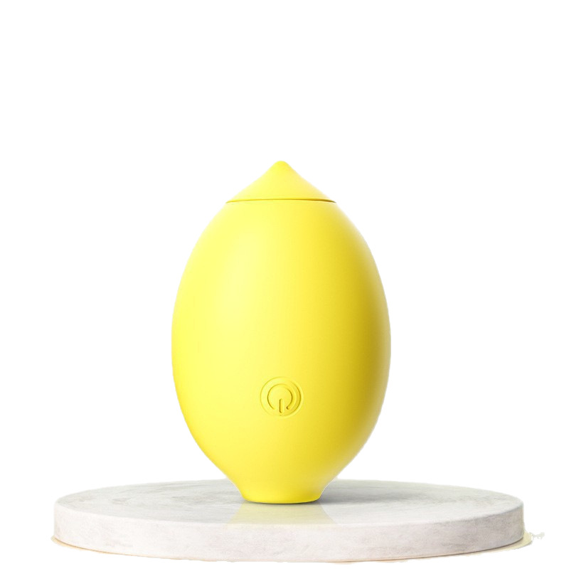 Yellow lemon-shaped clitoral suction vibrator on white display stand