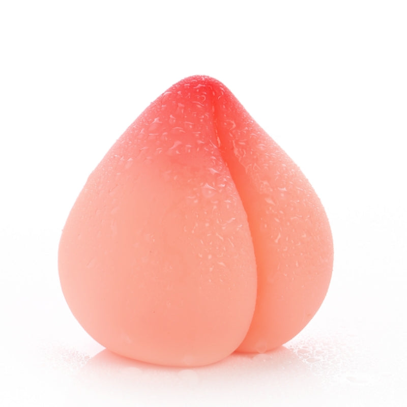 Peach-shaped soft TPE manual male masturbator in flesh pink