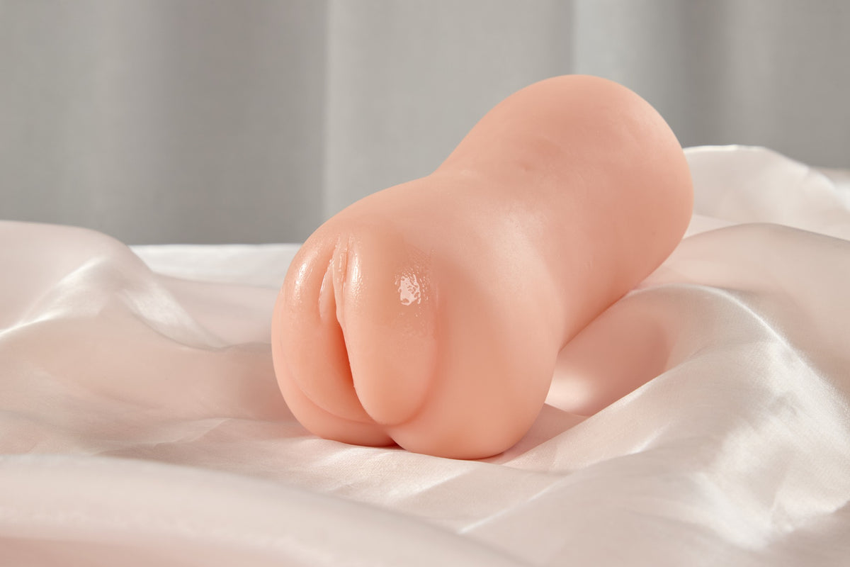 Angled view of the realistic pocket pussy male masturbator showing the soft body shape