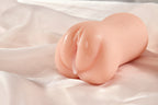 Realistic pocket pussy male masturbator shown on soft fabric with lubricant applied