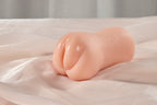 Side view of the compact realistic pocket pussy male masturbator on soft fabric