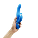 Blue silicone rabbit vibrator held in hand for size reference