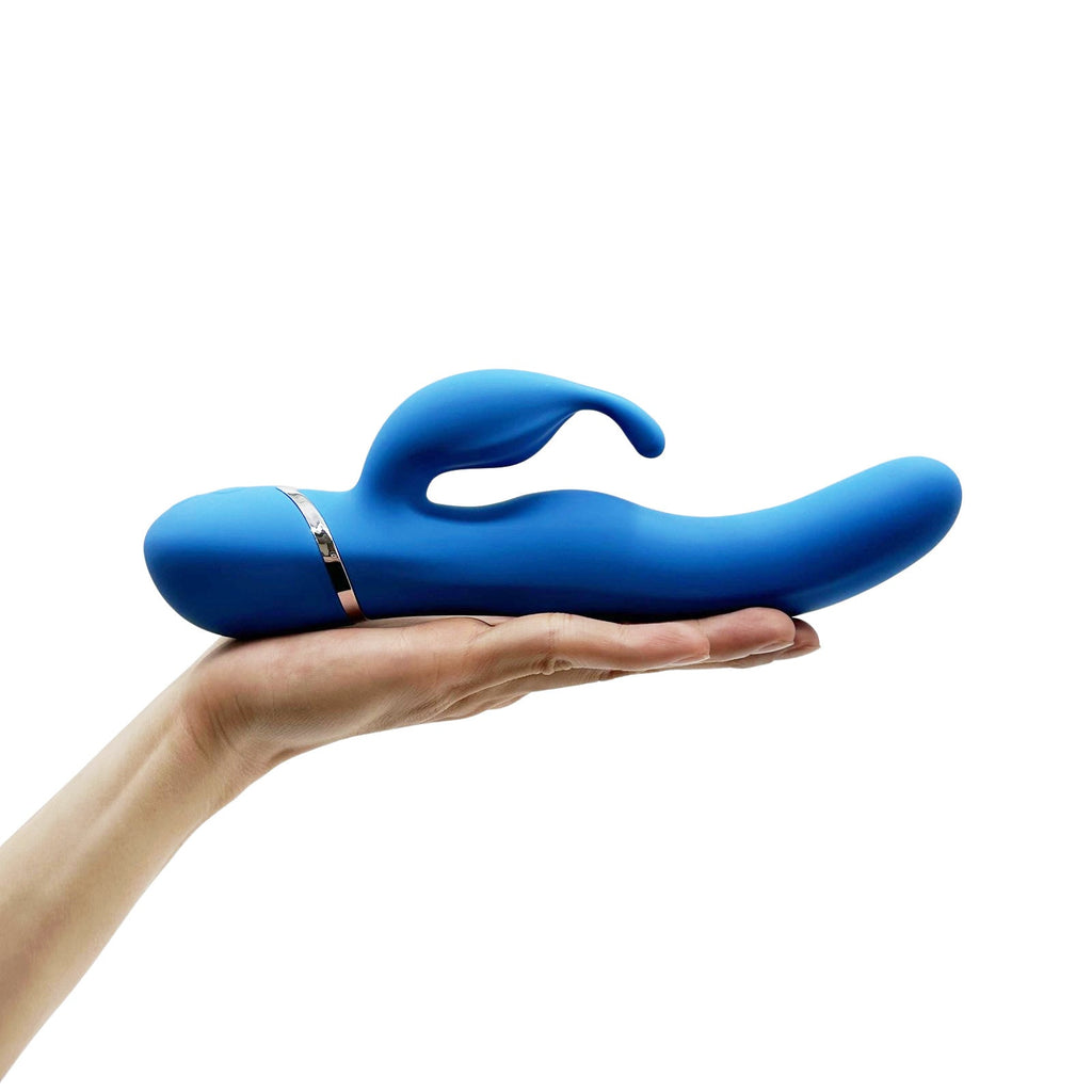 Blue silicone rabbit vibrator side profile resting on hand