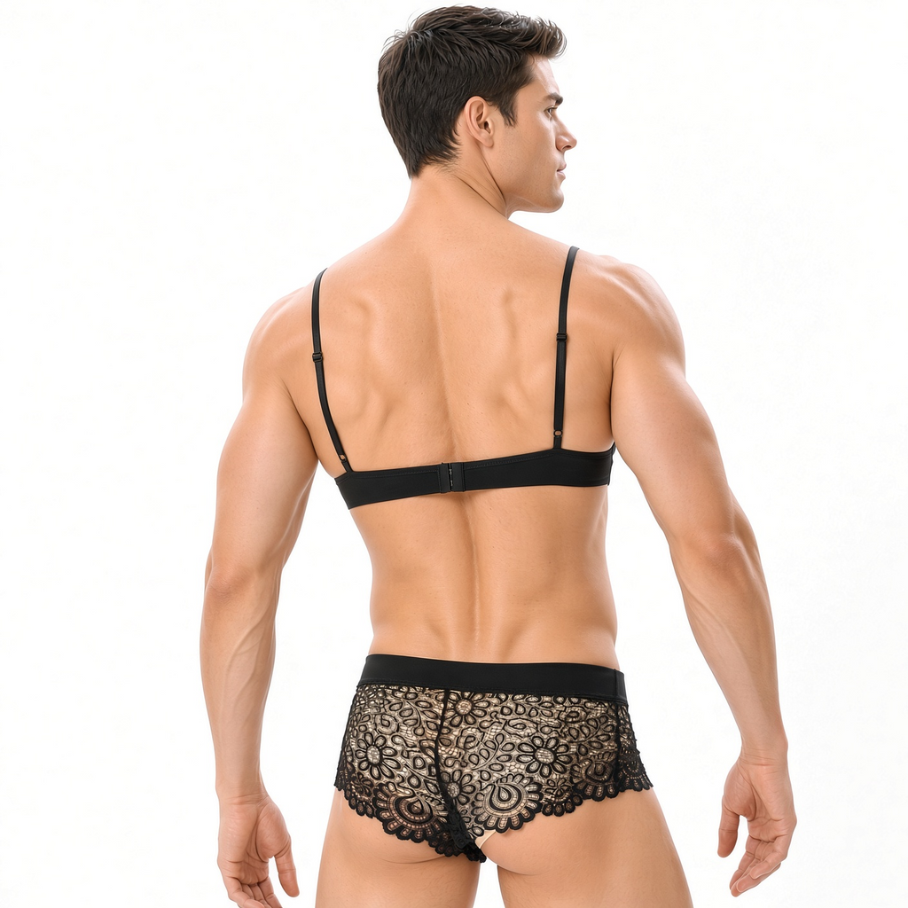 Male model back view wearing black lace bralette and black lace brief