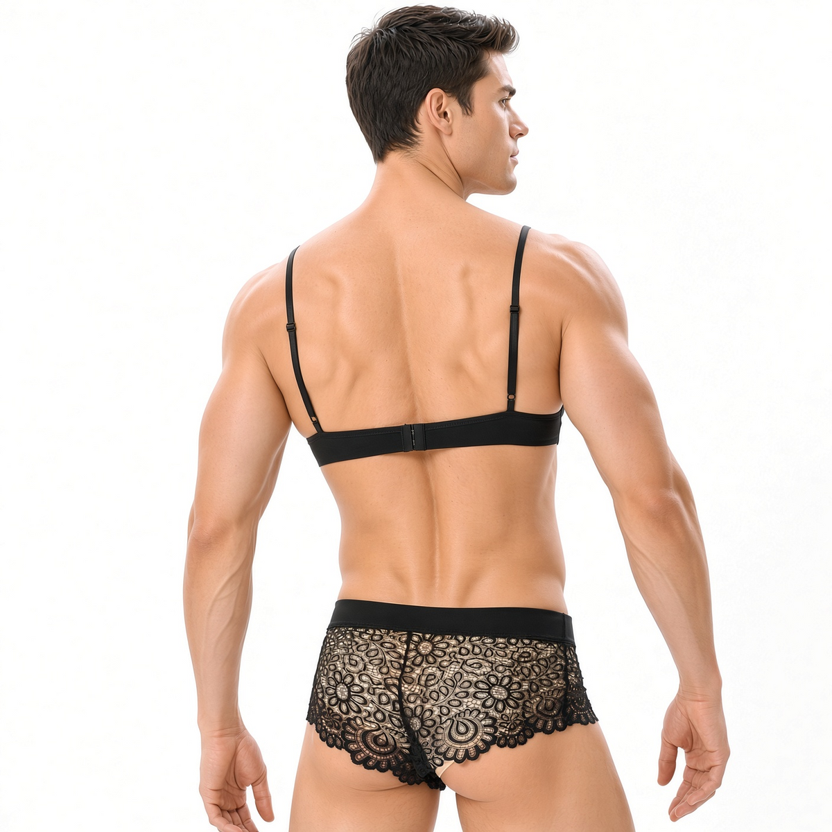Male model back view wearing black lace bralette and black lace brief