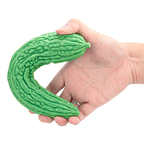 Green flexible bitter melon silicone dildo bent in hand