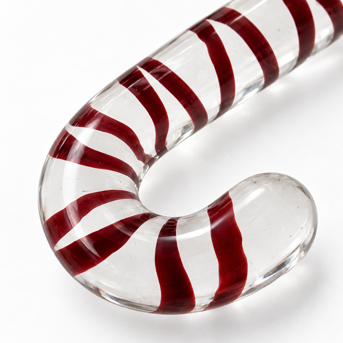 Close-up of clear glass surface and red spiral inlay detail