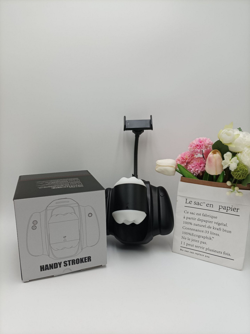 Automatic stroker shown beside its retail package with the phone holder attached