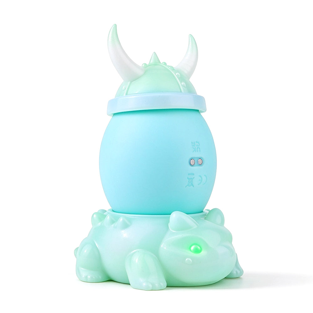 Mint green dragon-inspired massager assembled on original white background
