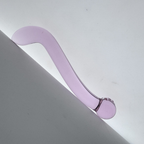 Angled view of curved double-ended purple glass dildo
