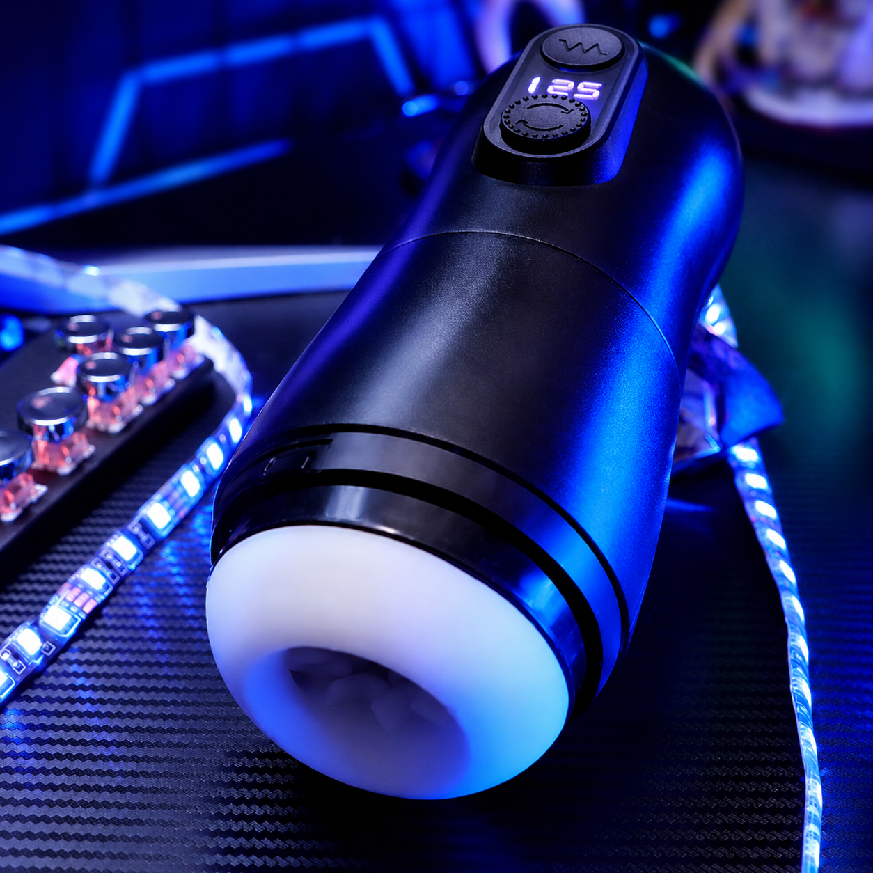 Black automatic male masturbator angled close-up with LED controls