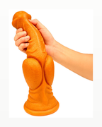 Hand holding orange equine-style textured silicone fantasy dildo for scale