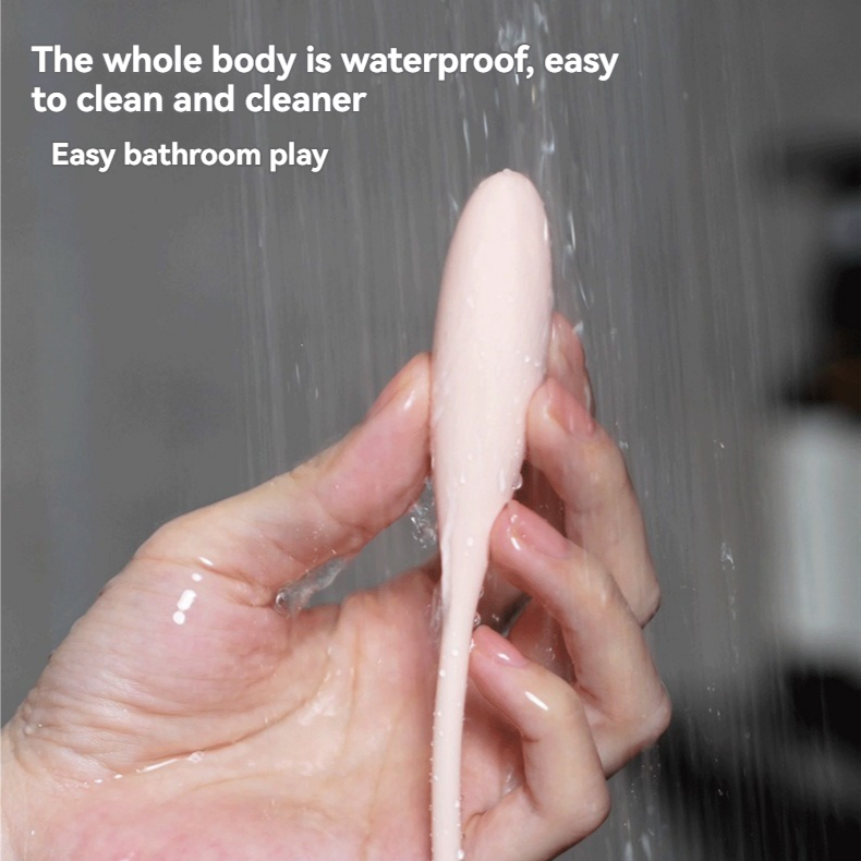 Pink mini vibrator rinsed under running water for waterproof cleaning.