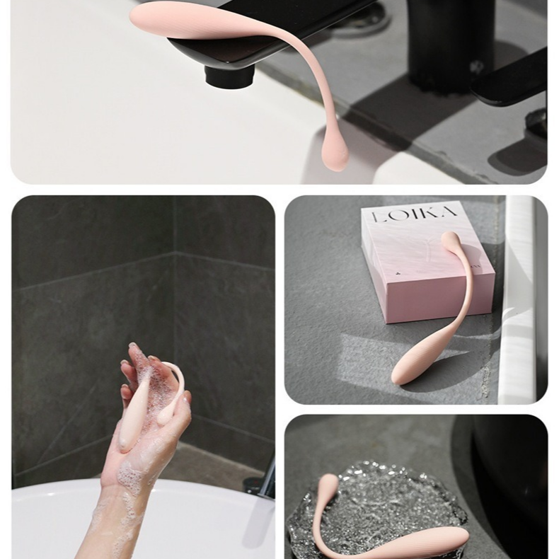 Pink mini vibrator shown near a bath and shower to demonstrate waterproof cleaning.