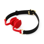 Red silicone open mouth gag with an adjustable black buckle strap