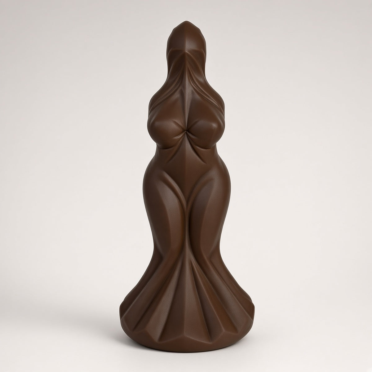 Coffee sculpted goddess-form curved silicone dildo on a clean light background
