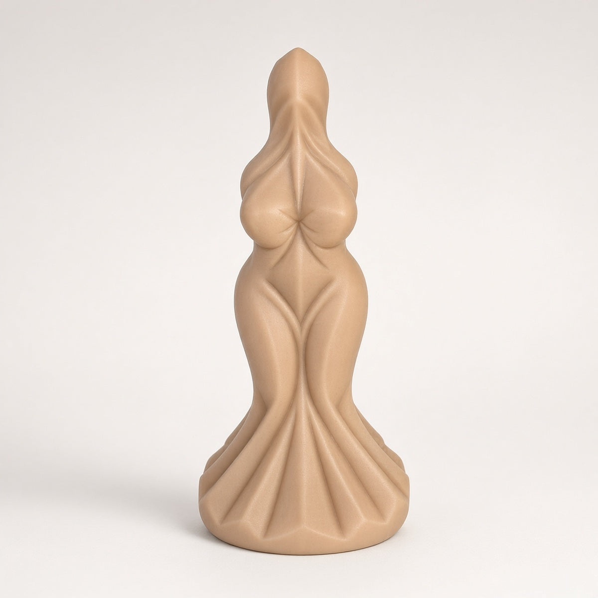 Skin Tone sculpted goddess-form curved silicone dildo on a clean light background