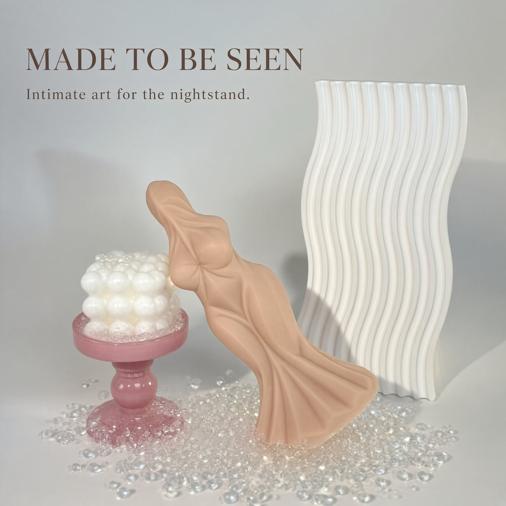 Skin Tone sculpted goddess-form curved silicone dildo styled as intimate art for a nightstand