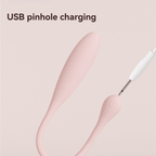 USB pinhole charging cable beside the pink mini vibrator control button.