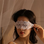 Model wearing a white floral lace tie-on sensory blindfold