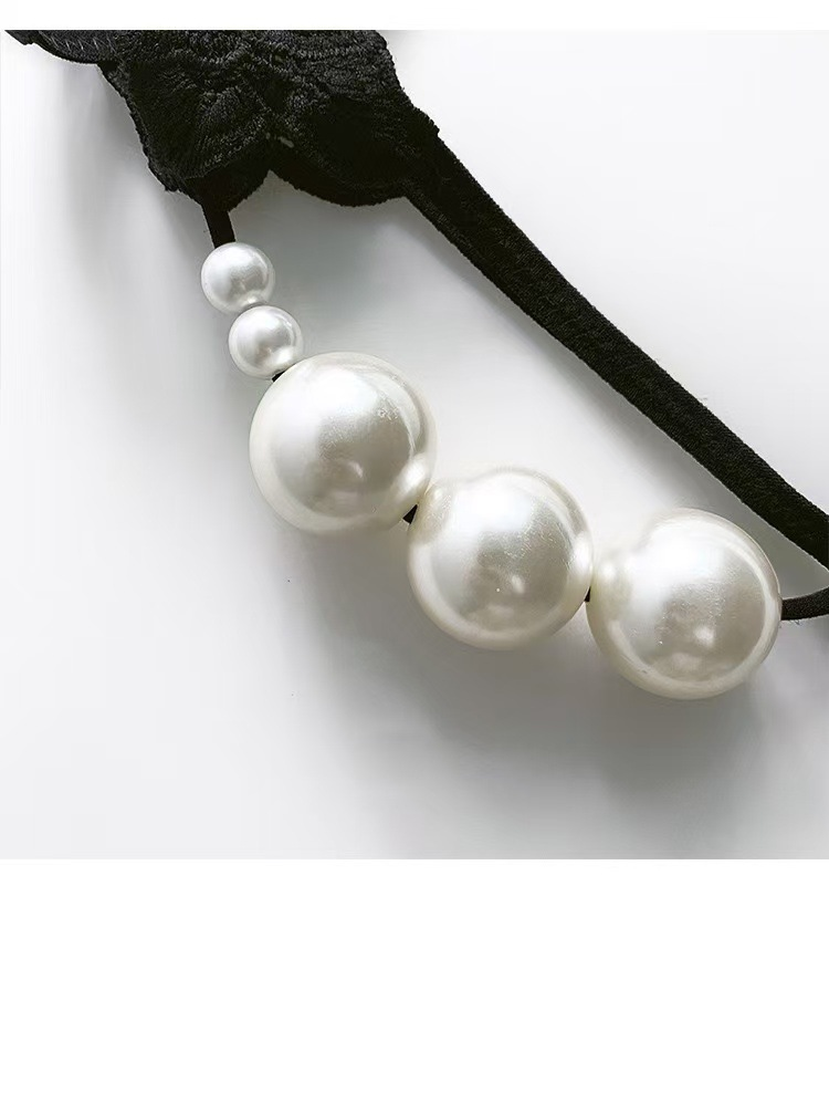 Close-up of floral embroidery and narrow straps